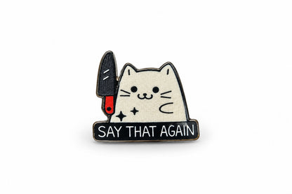 Close-up product photo of white cat with knife Say That Again pin