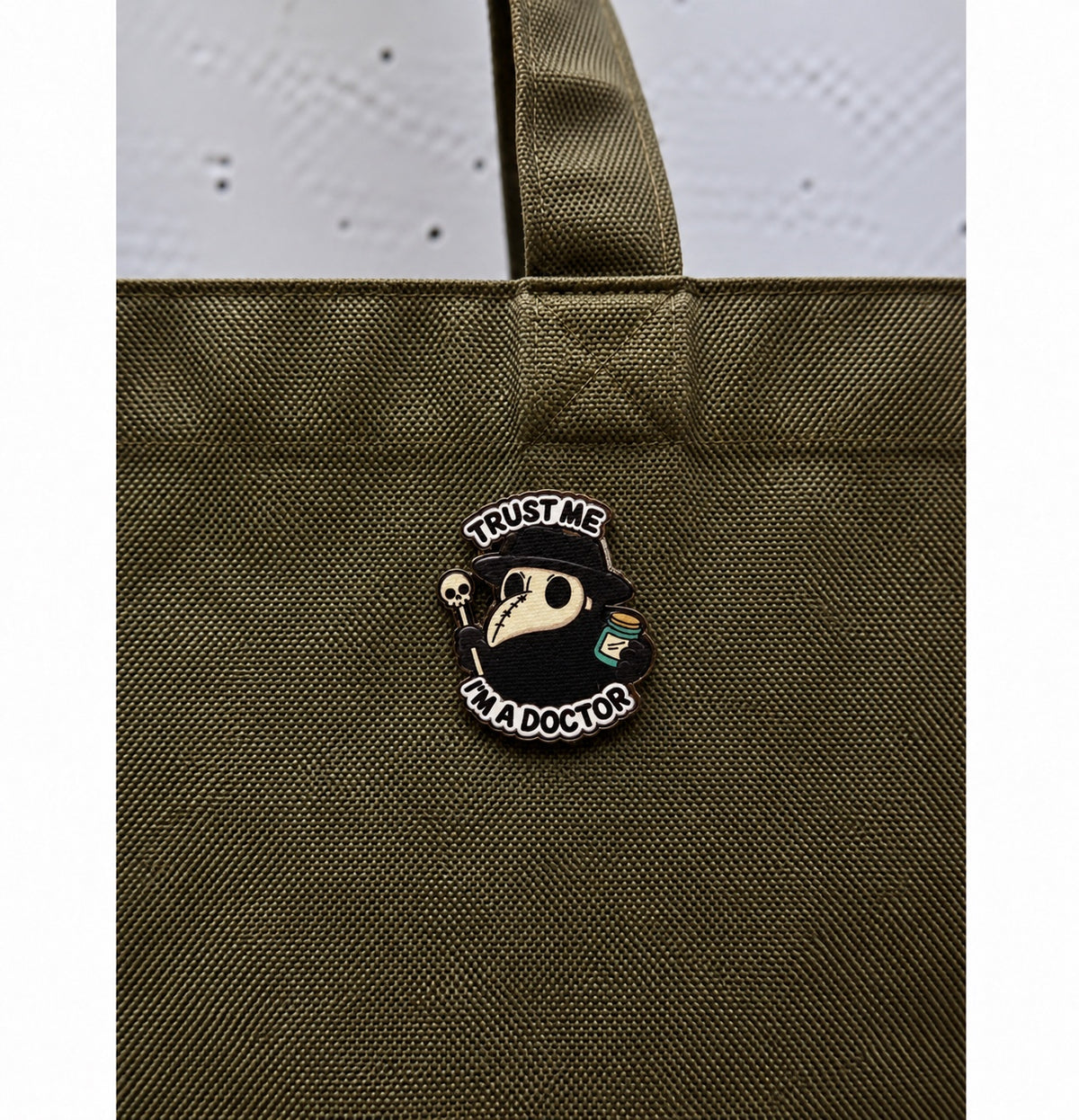 Trust Me I'm a Doctor wooden printed pin on olive green bag